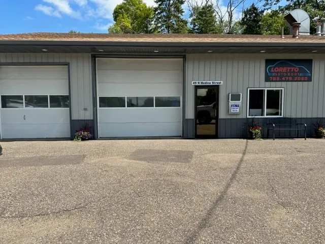 Front of Loretto Auto Body at 49 N Medina Street, Loretto, MN 55357, with the shop sign and customer entrance